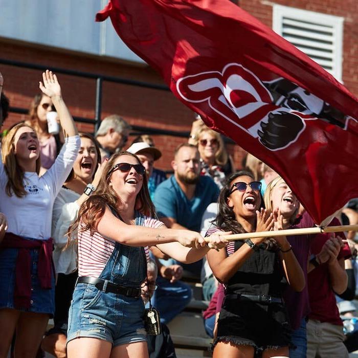 Students cheering LR football in stands